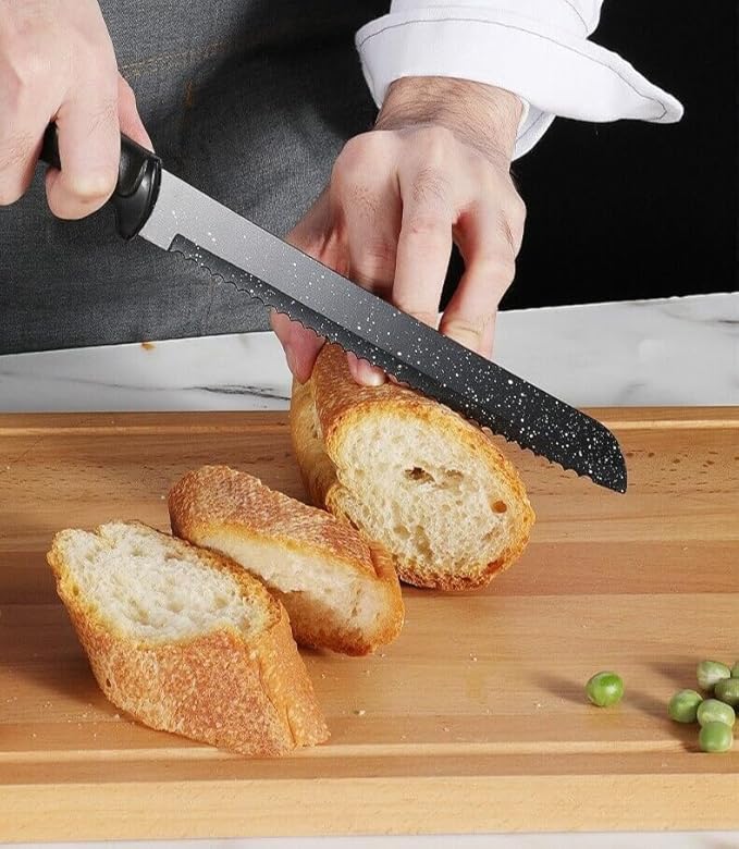 Person slicing bread with a knife on a wooden cutting board
