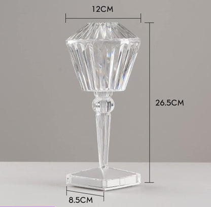 Clear glass candle holder with dimensions on a gray background