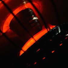 Close-up of a red light bulb with a dark background