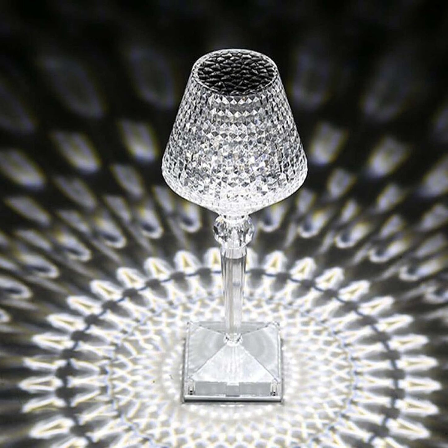 Crystal table lamp casting a patterned shadow on a dark background