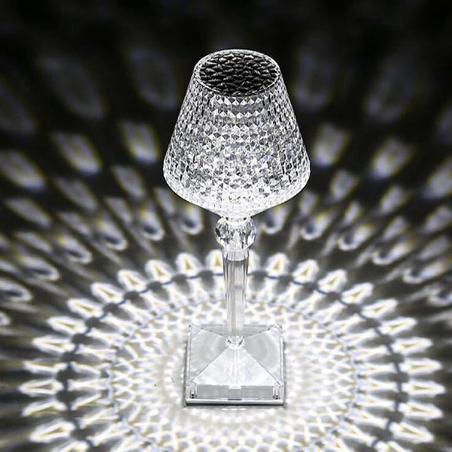 Crystal table lamp casting a patterned shadow on a dark background