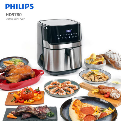 Philips digital air fryer with various cooked foods displayed around it on a white background
