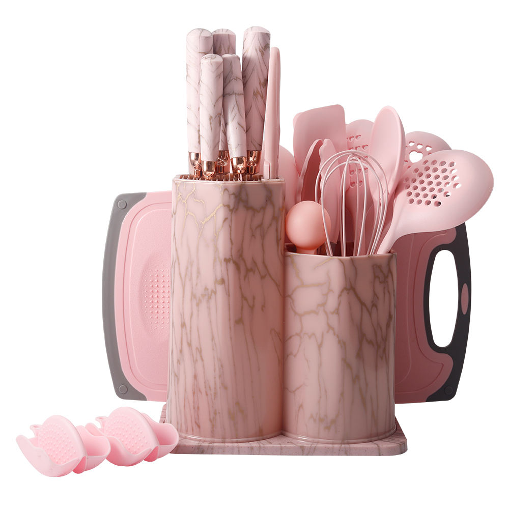 Set of pink kitchen utensils in marble-patterned holders