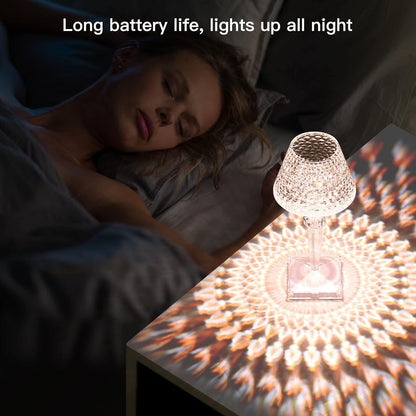 Woman lying in bed with a crystal-style lamp casting a warm glow on the nightstand.